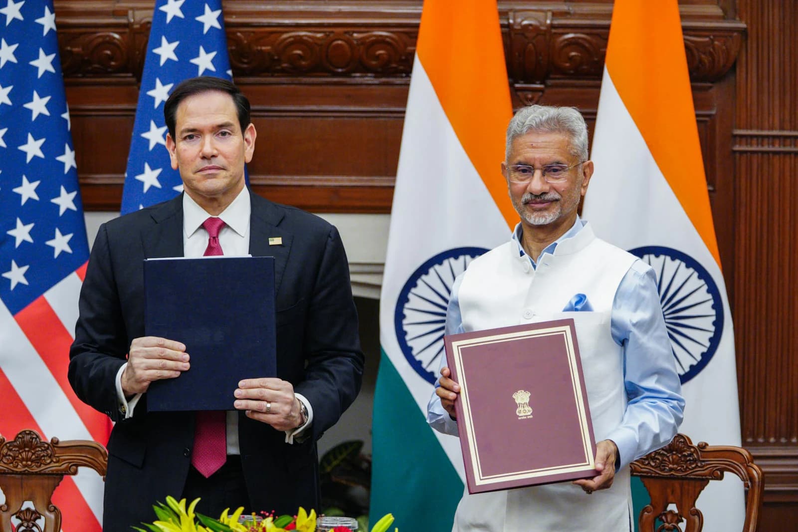 Secretary Rubio and India's External Affairs Minister holding documents at a ceremony.