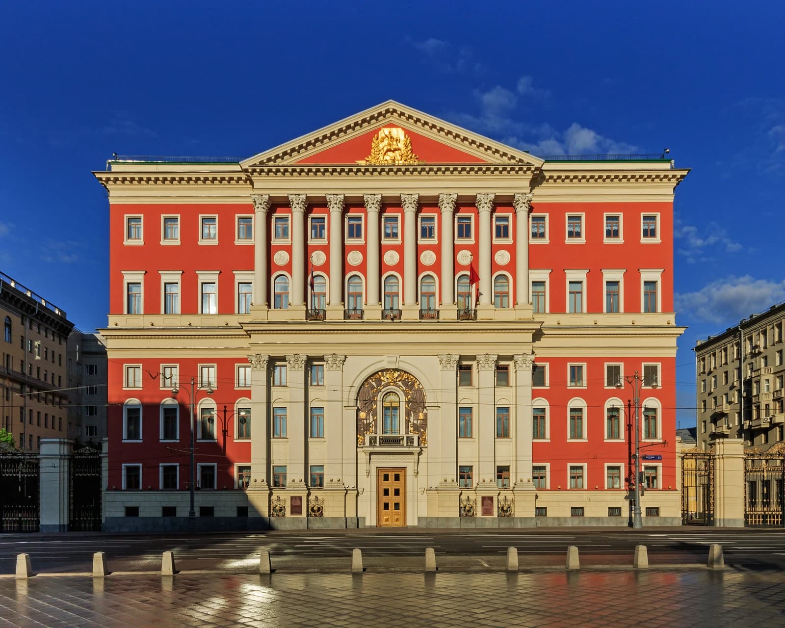 Exterior view of Tverskaya 13, a grand red and white building in Moscow.