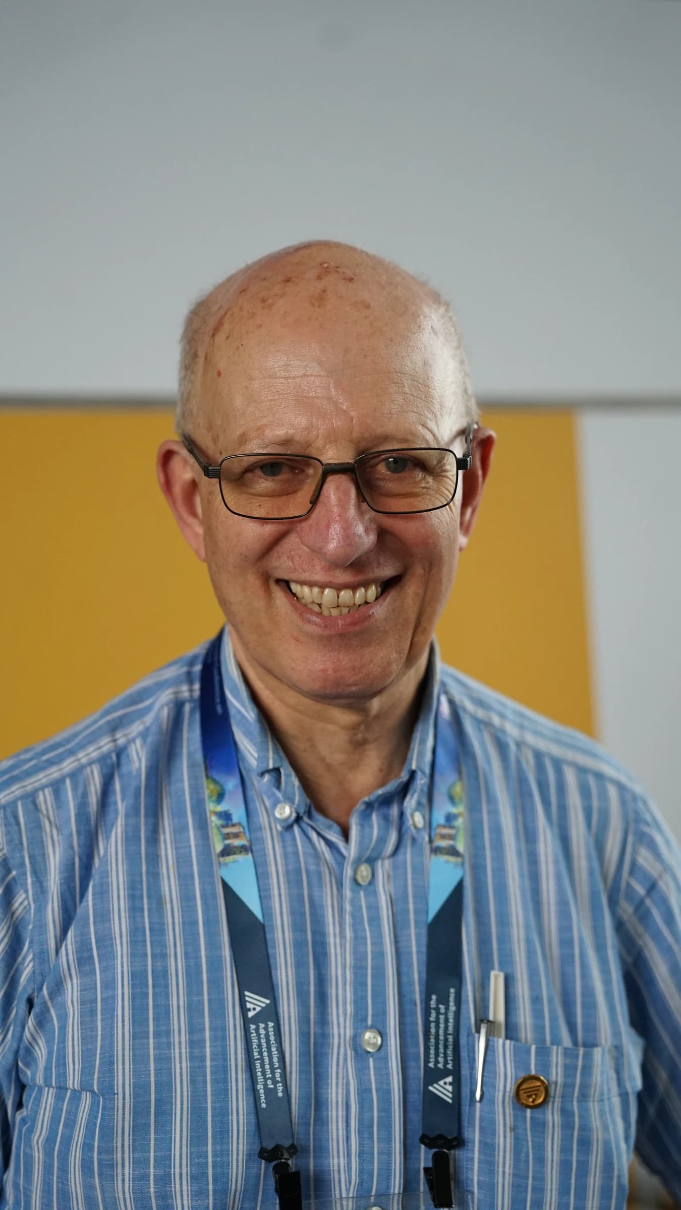 Anthony Cohn, AI researcher, smiling at the AAAI conference.