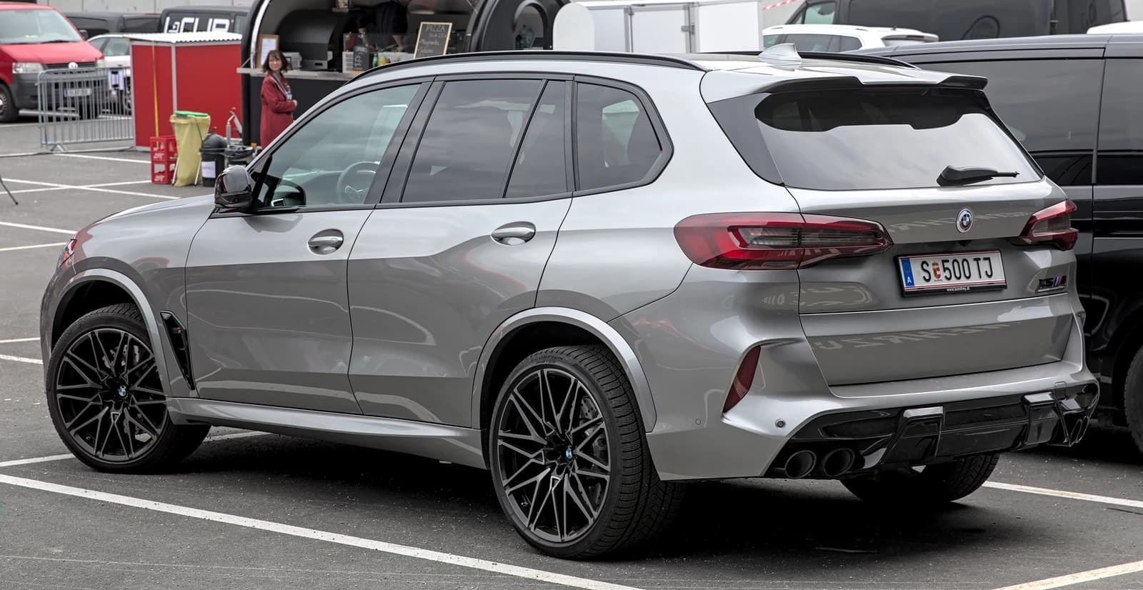 Silver BMW X5 M (G05) luxury SUV parked in a lot.