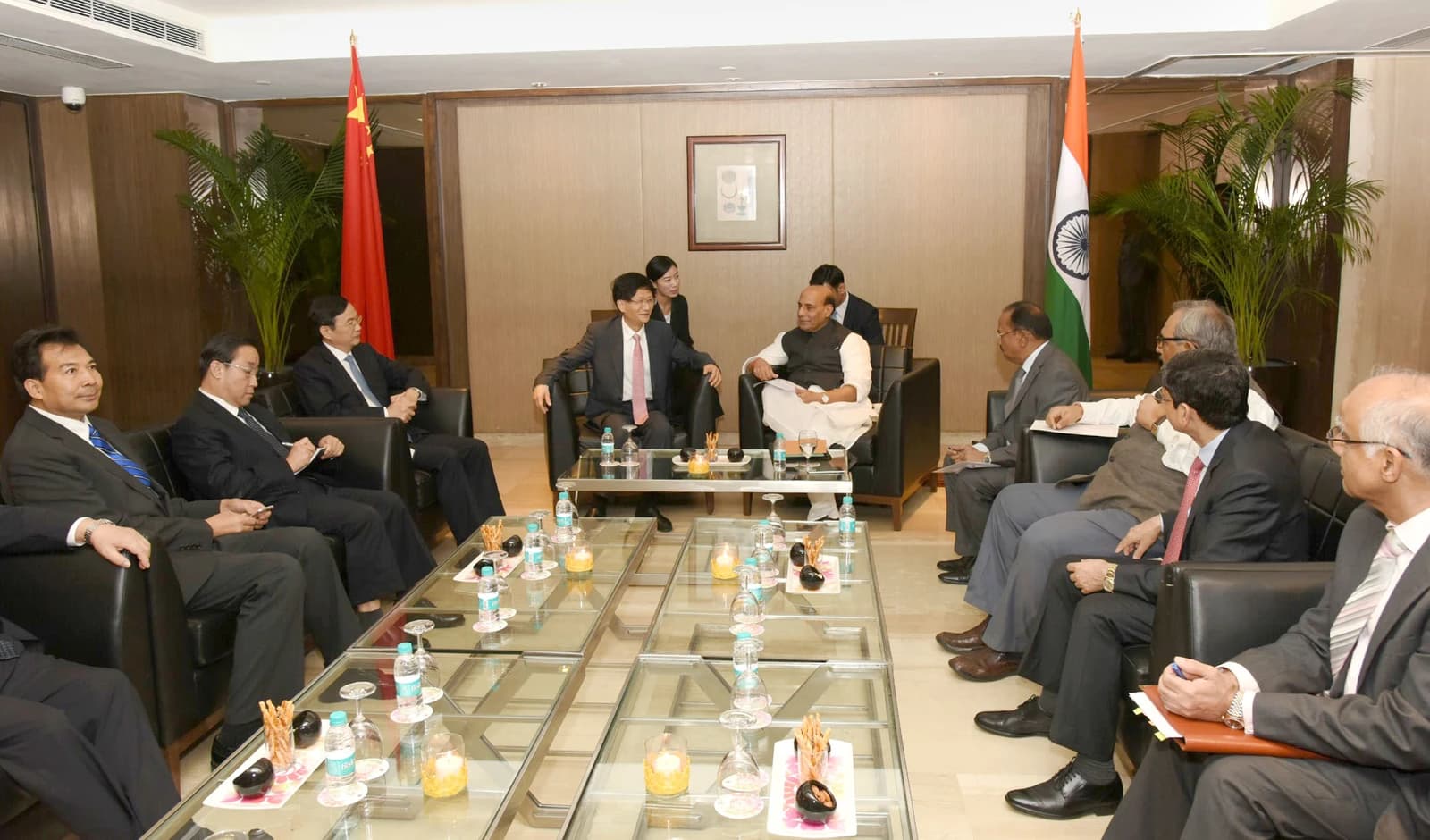Chinese delegation members and Indian officials during a meeting in a conference room.