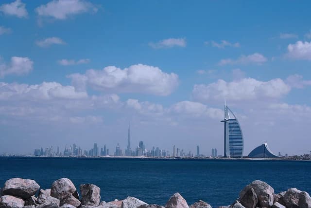 Dubai skyline with the iconic Burj Al Arab hotel and other buildings across the water.