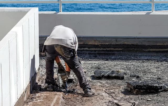 Construction worker using a jackhammer on a building site in Lysekil.