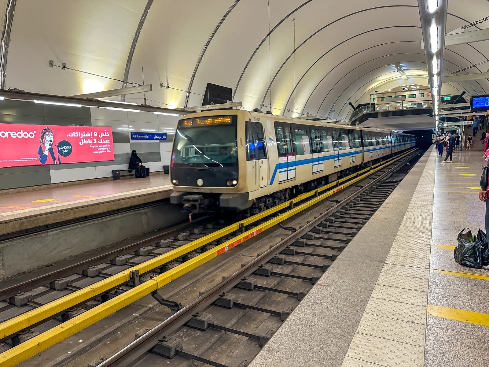 A subway train arriving or departing from a station platform in Algiers.