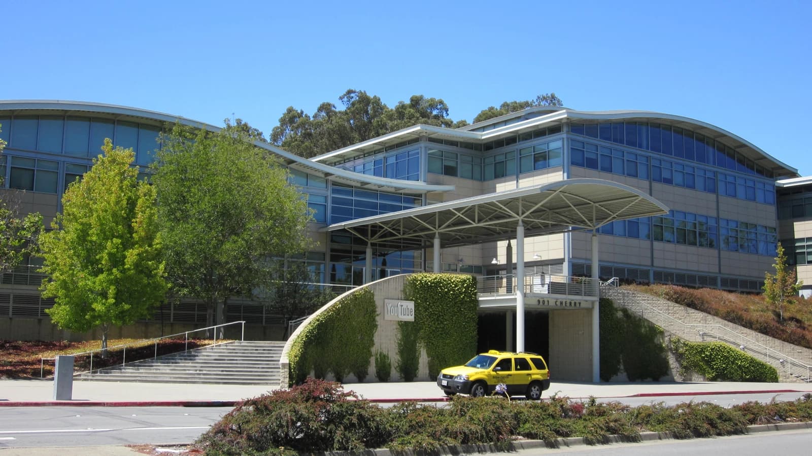 Exterior of the YouTube headquarters building in San Bruno, California, on a sunny day.