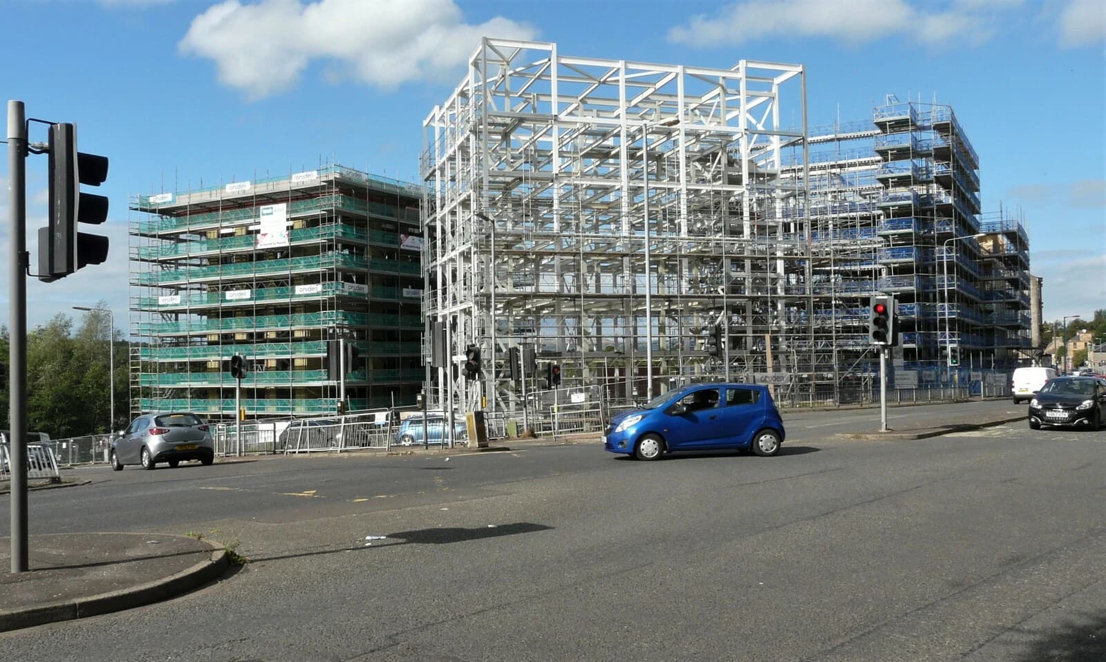 New homes under construction with scaffolding visible on multiple buildings.