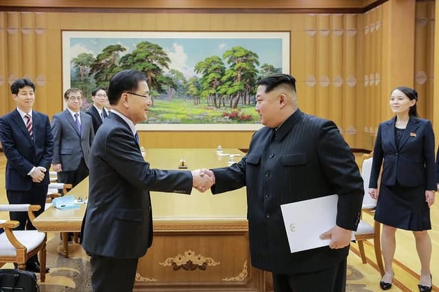 Chung Eui-yong, South Korean National Security Advisor, shaking hands with Kim Jong-un, leader of North Korea.