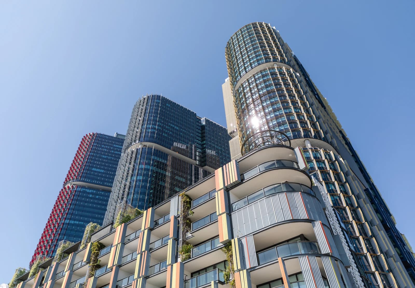 Modern high-rise buildings with glass facades and balconies in Sydney, Australia.
