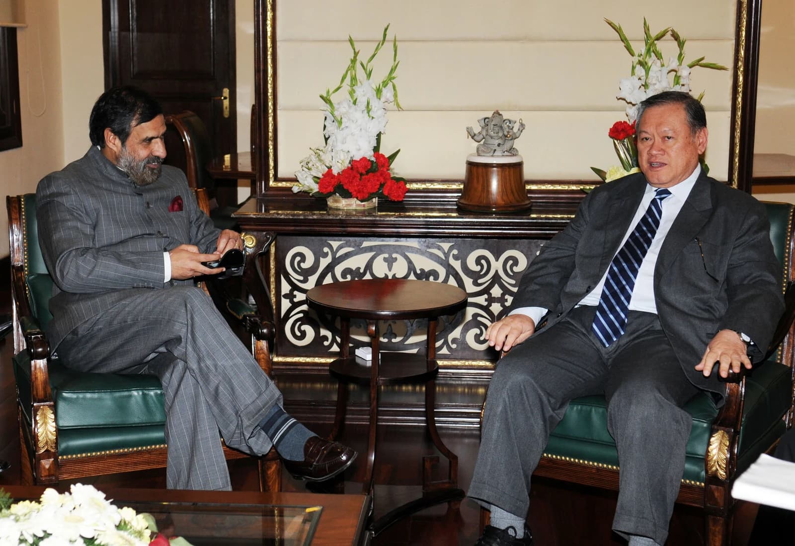 Pehin Dato Lim Jack Seng and Shri Anand Sharma sitting in chairs during a meeting.