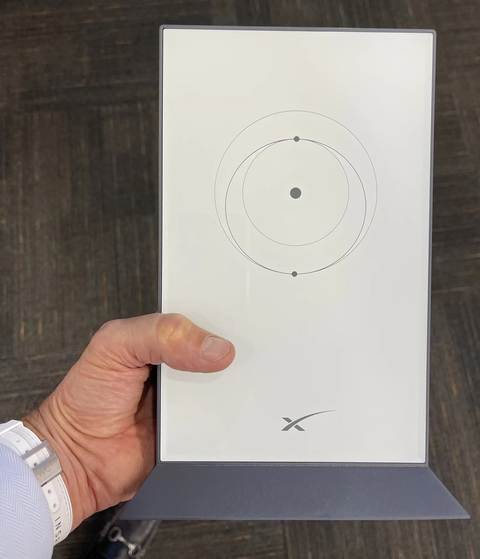 Hand holding a SpaceX Starlink User Terminal v2.