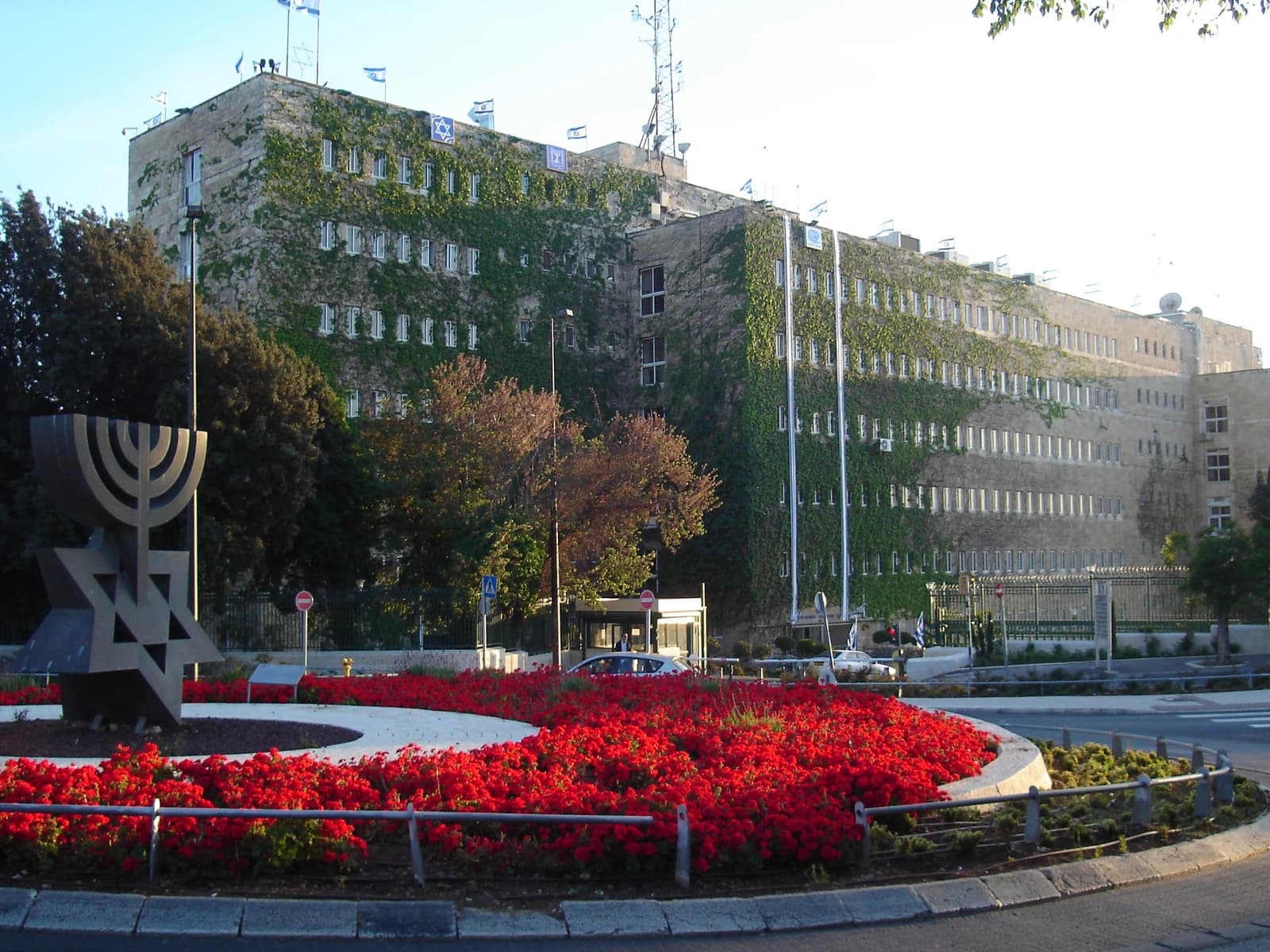 Exterior view of the Israel Ministry of Finance building in Jerusalem with an Israeli flag.