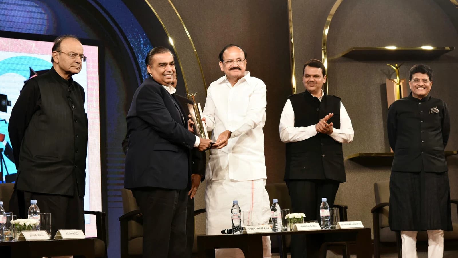 Mukesh Ambani receives an award from Vice President Venkaiah Naidu in Mumbai.
