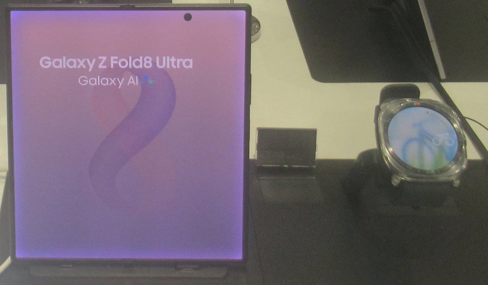 Samsung Galaxy Z Fold8 Ultra smartphone screen and a Samsung Galaxy Watch Ultra 2 on display.