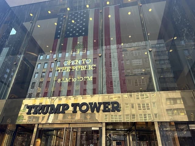 Exterior of Trump Tower building showing the entrance and reflective glass facade.