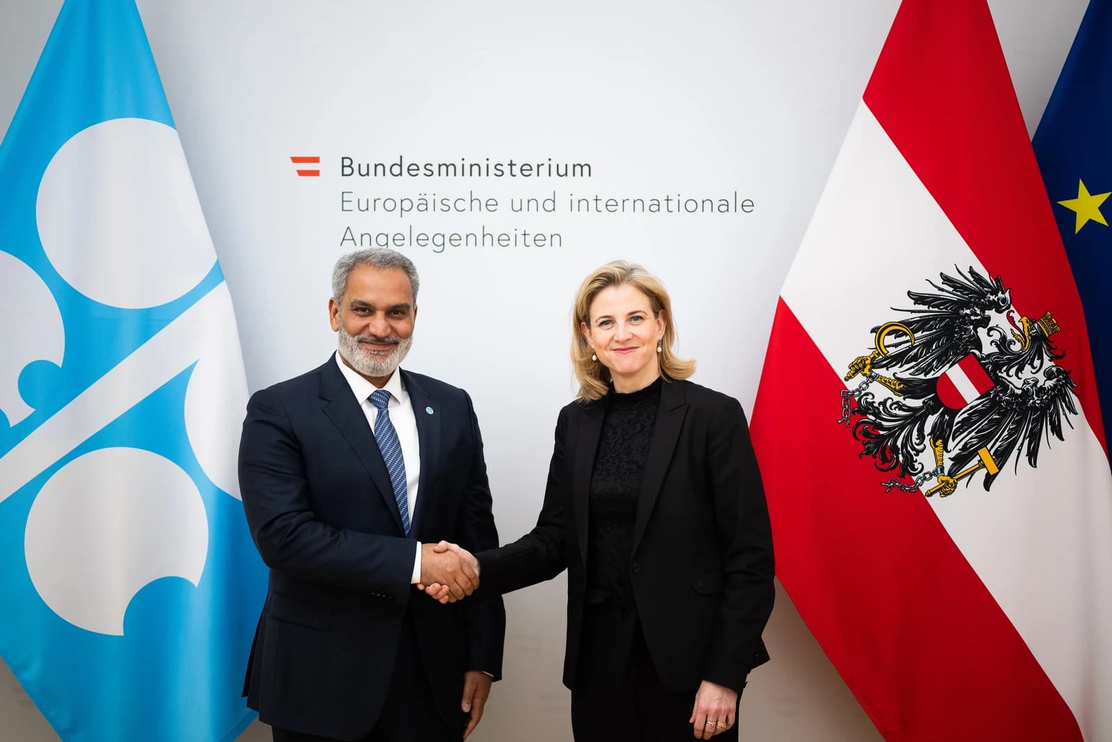 OPEC Secretary General Haitham Al Ghais and Austrian Foreign Minister Beate Meinl-Reisinger shaking hands.