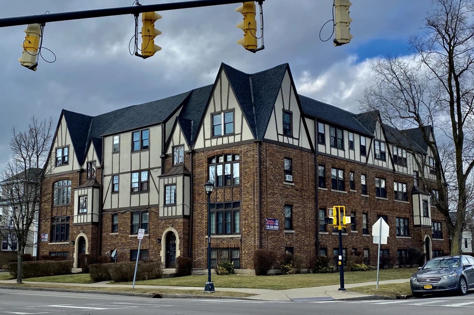 Avon Lea Apartments, a brick and Tudor-style building with multiple stories and gables.