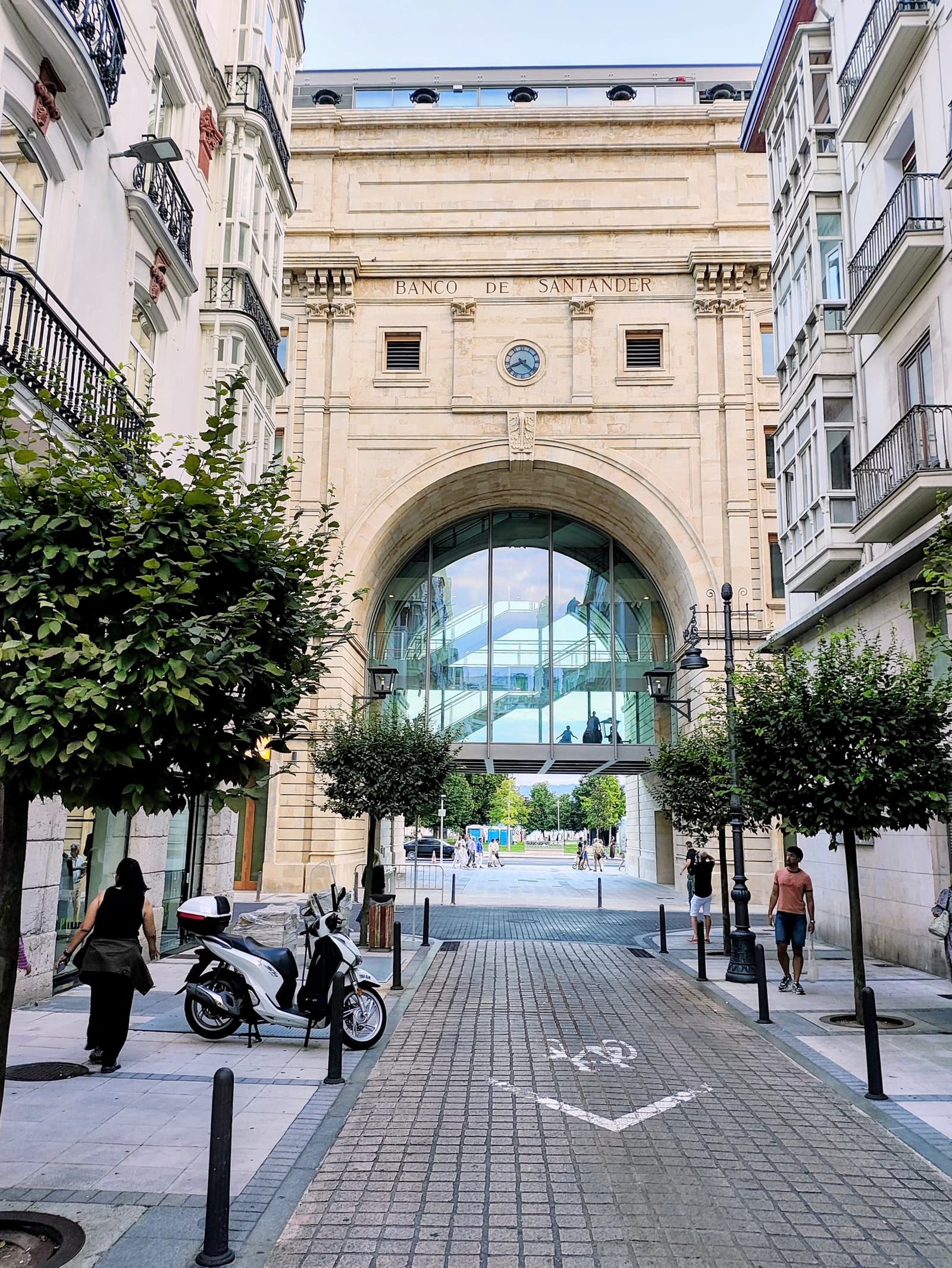 View of the Banco Santander building facade from a pedestrian street.