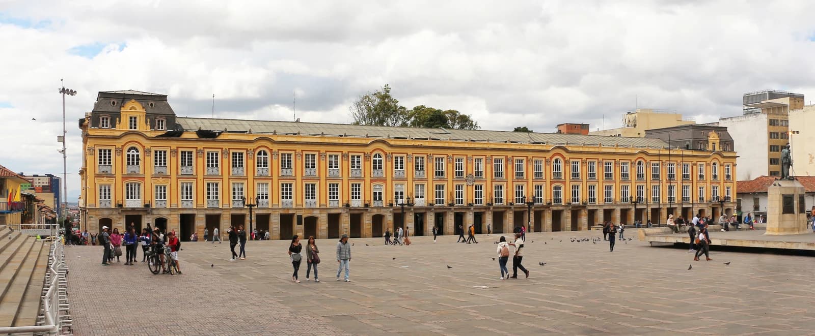 Palacio Liévano building in Bogotá, with people walking in front on a cloudy day.