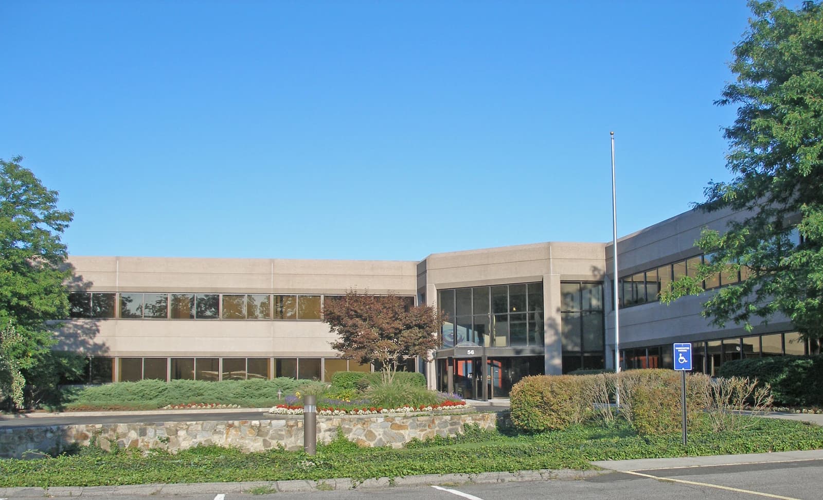 Exterior of Gartner headquarters building with landscaping and clear blue sky.