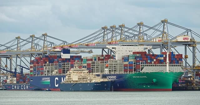 CMA CGM Kourou, CMA CGM Louvre, and Gas Agility ships docked in a busy port.
