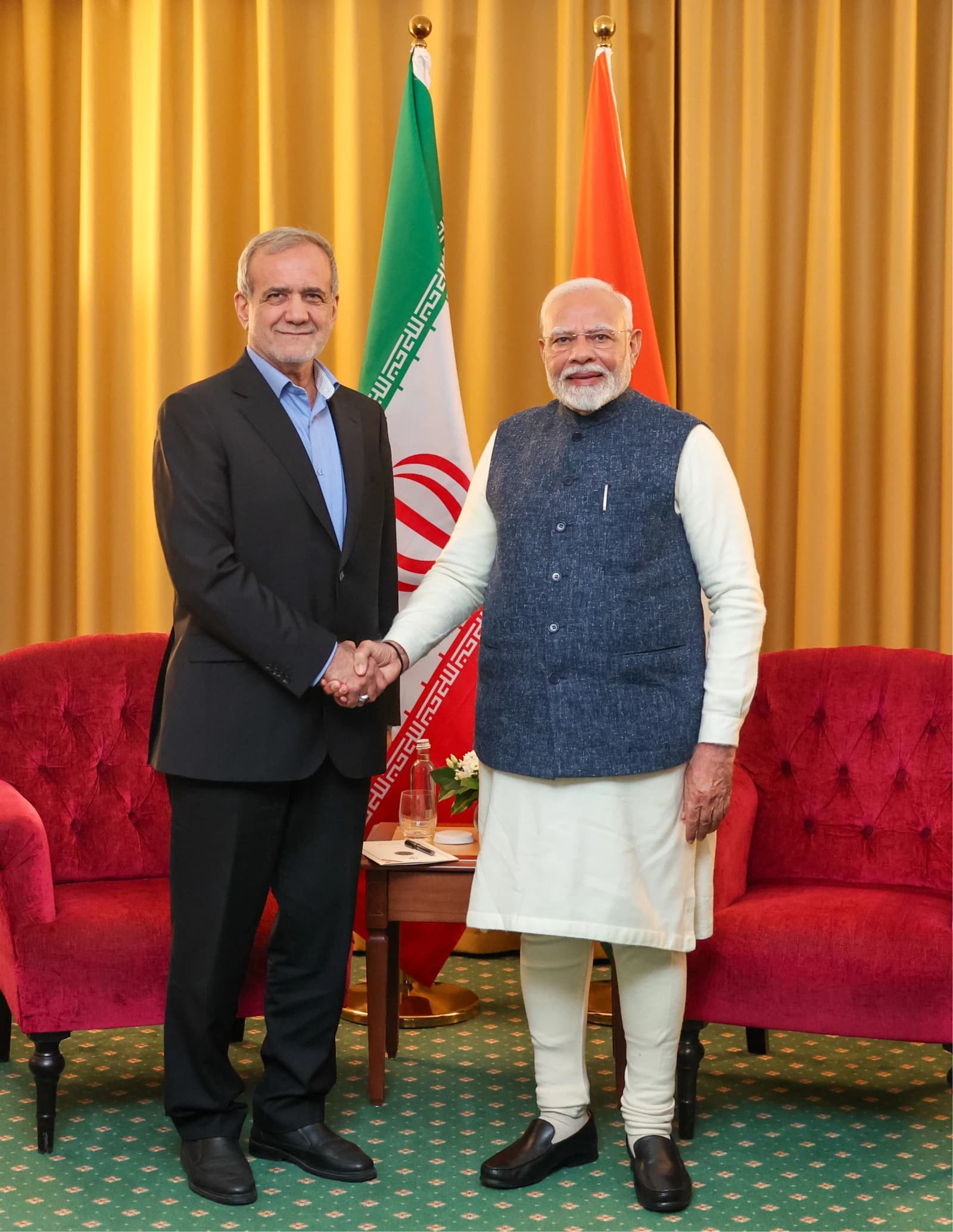 Iranian President Masoud Pezeshkian shakes hands with Indian Prime Minister Narendra Modi.