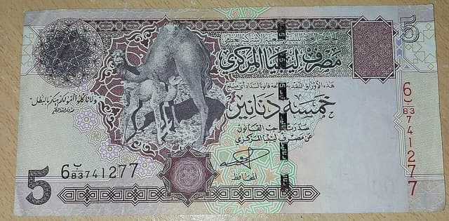 Five Libyan Dinar banknote featuring a camel and two calves.