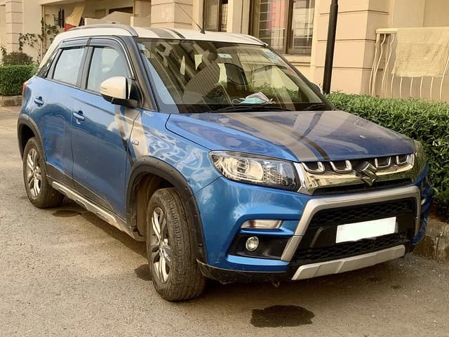 Blue Maruti Suzuki Vitara Brezza ZDi Plus compact SUV parked on a street.