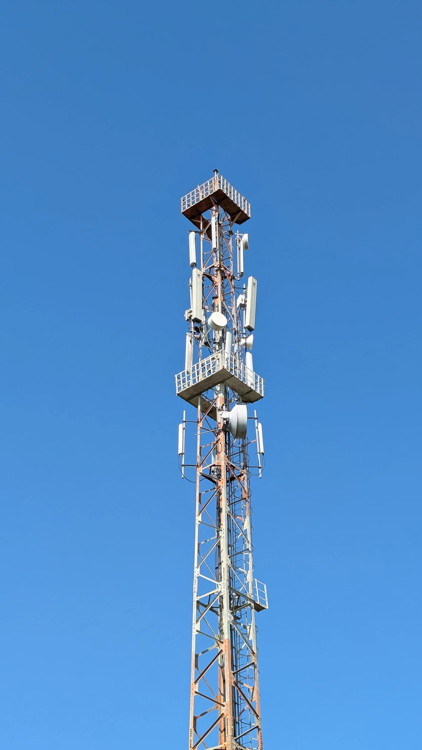 BSNL 4G telecom tower in Todabhim with various antennas under blue sky.
