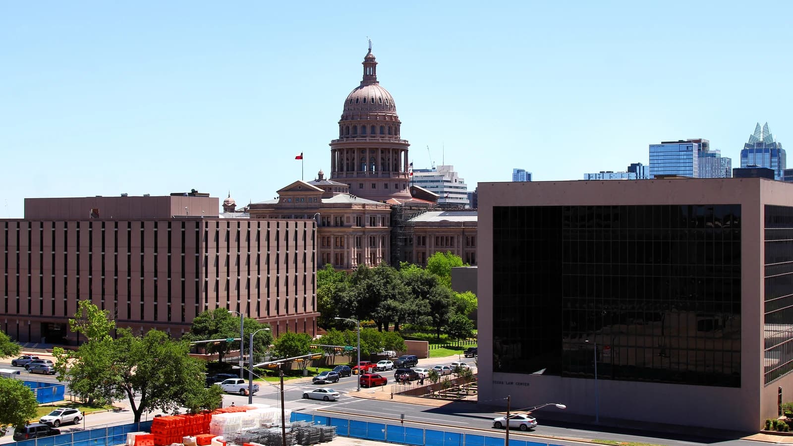 Buildings in Austin, Texas, including the State Capitol under a blue sky.