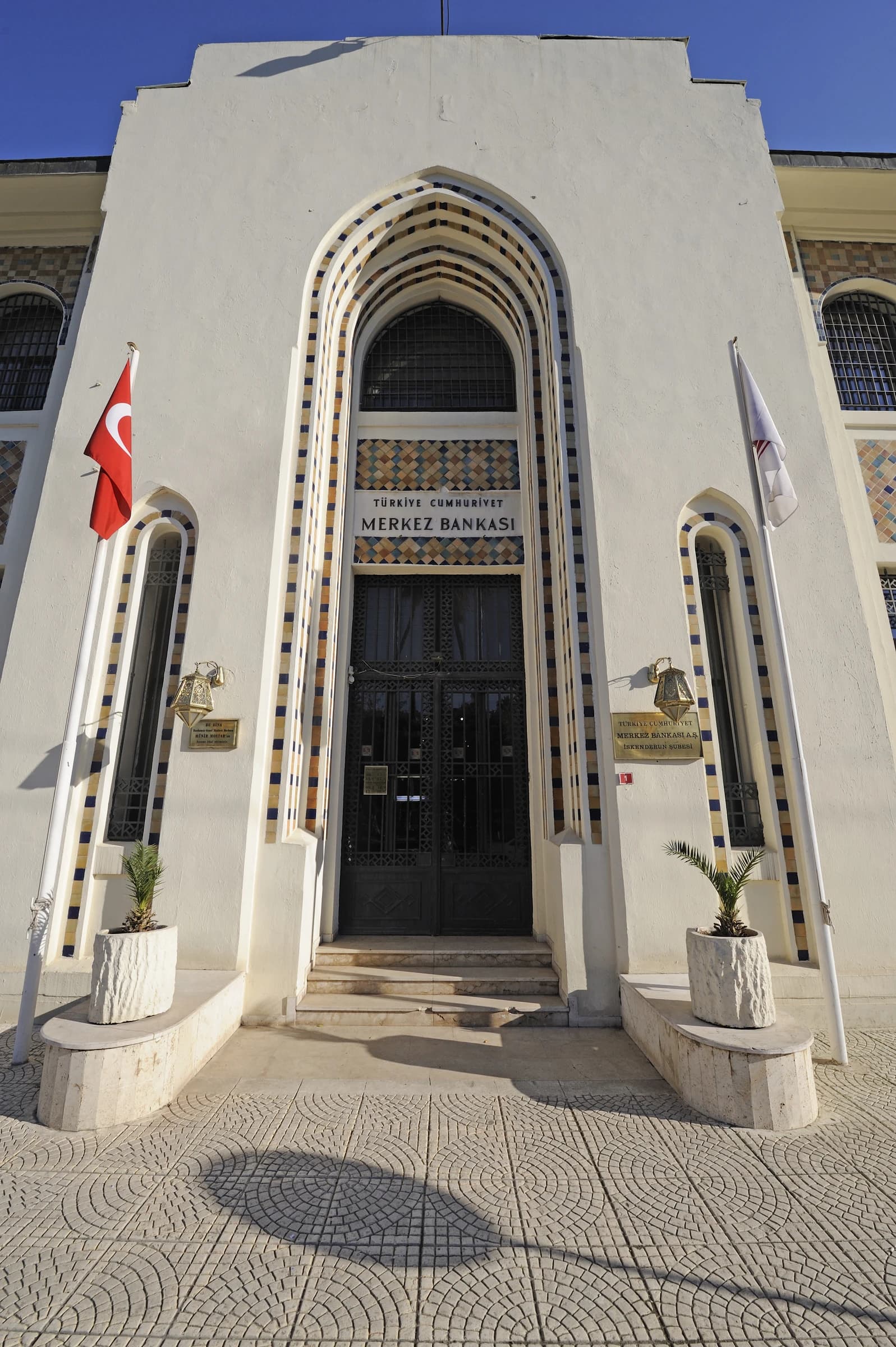 Exterior facade of the Central Bank of the Republic of Turkey building, with an arched entrance.