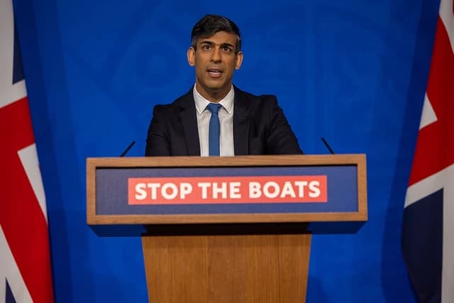 Rishi Sunak, UK Prime Minister, speaking at a podium with microphones.