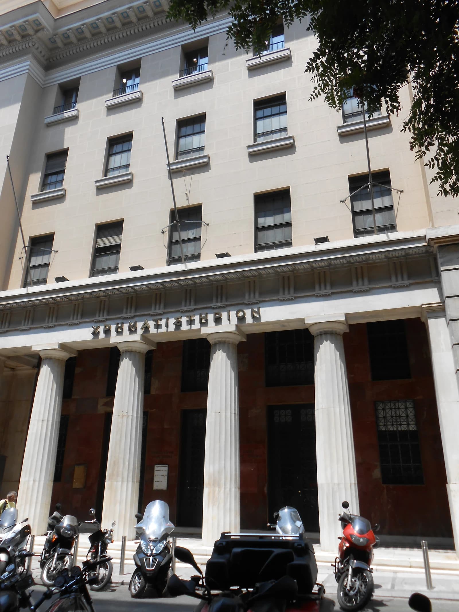 Exterior of the old Athens Stock Exchange building with columns and windows.