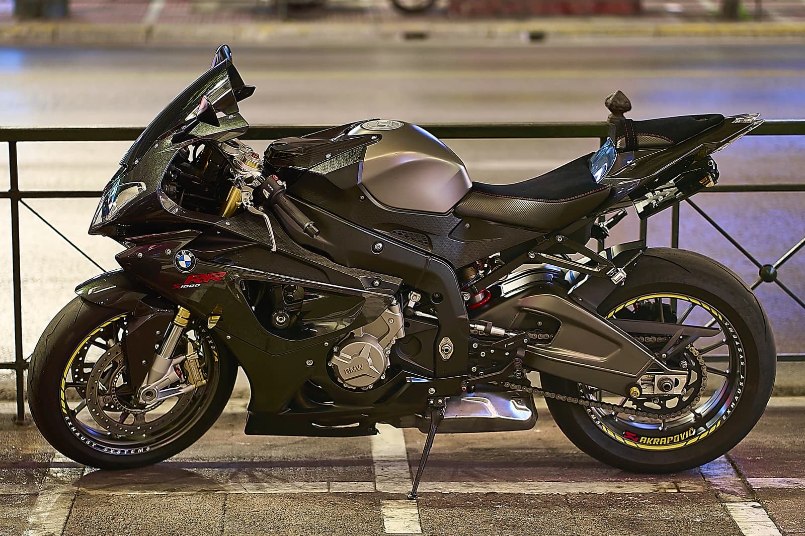 A black BMW S 1000 RR motorcycle parked on a street in Athens, Greece.