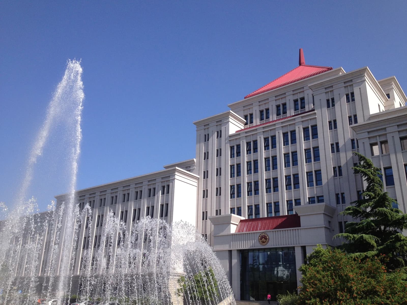 Exterior of the general building at the Chinese Academy of Governance with fountains.