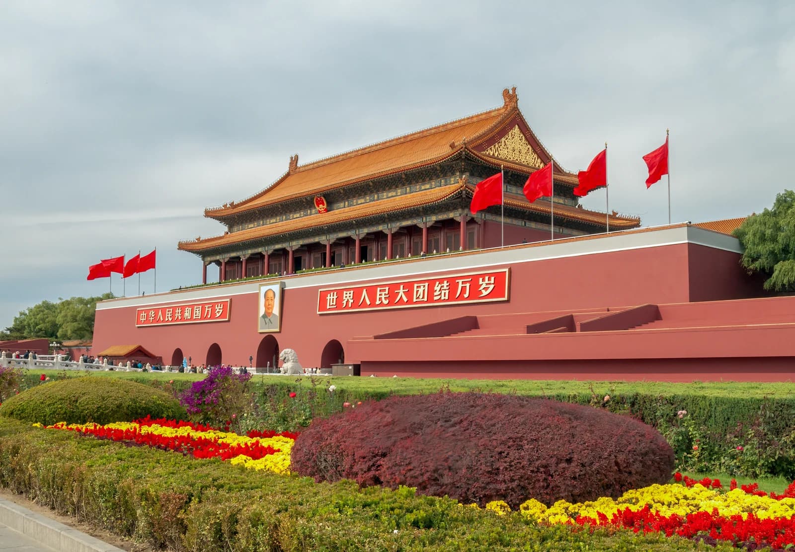 Tiananmen Gate with a large portrait of Mao Zedong and red flags flying.