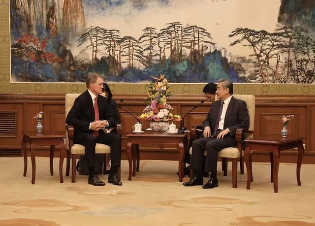 Ambassador David Perdue sitting across from Chinese Foreign Minister Wang Yi.