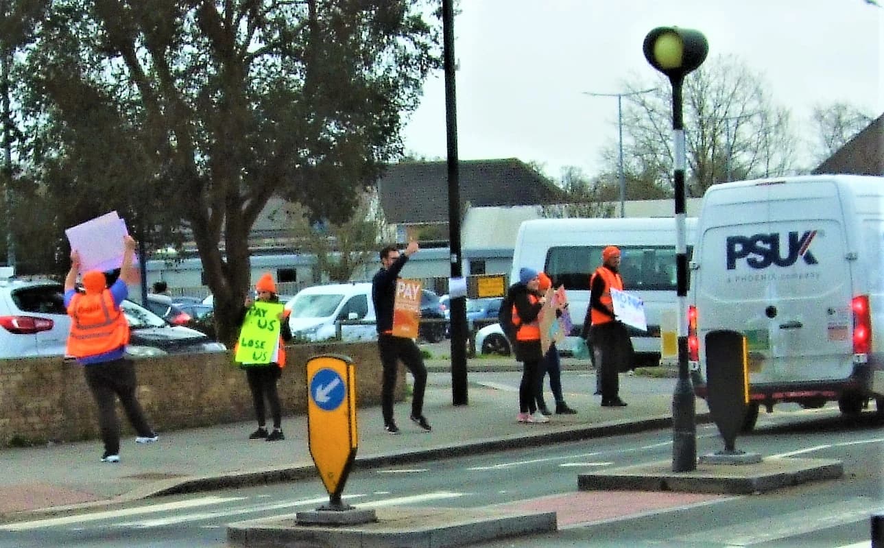 Junior doctors on strike holding signs outside West Middlesex Hospital, London.