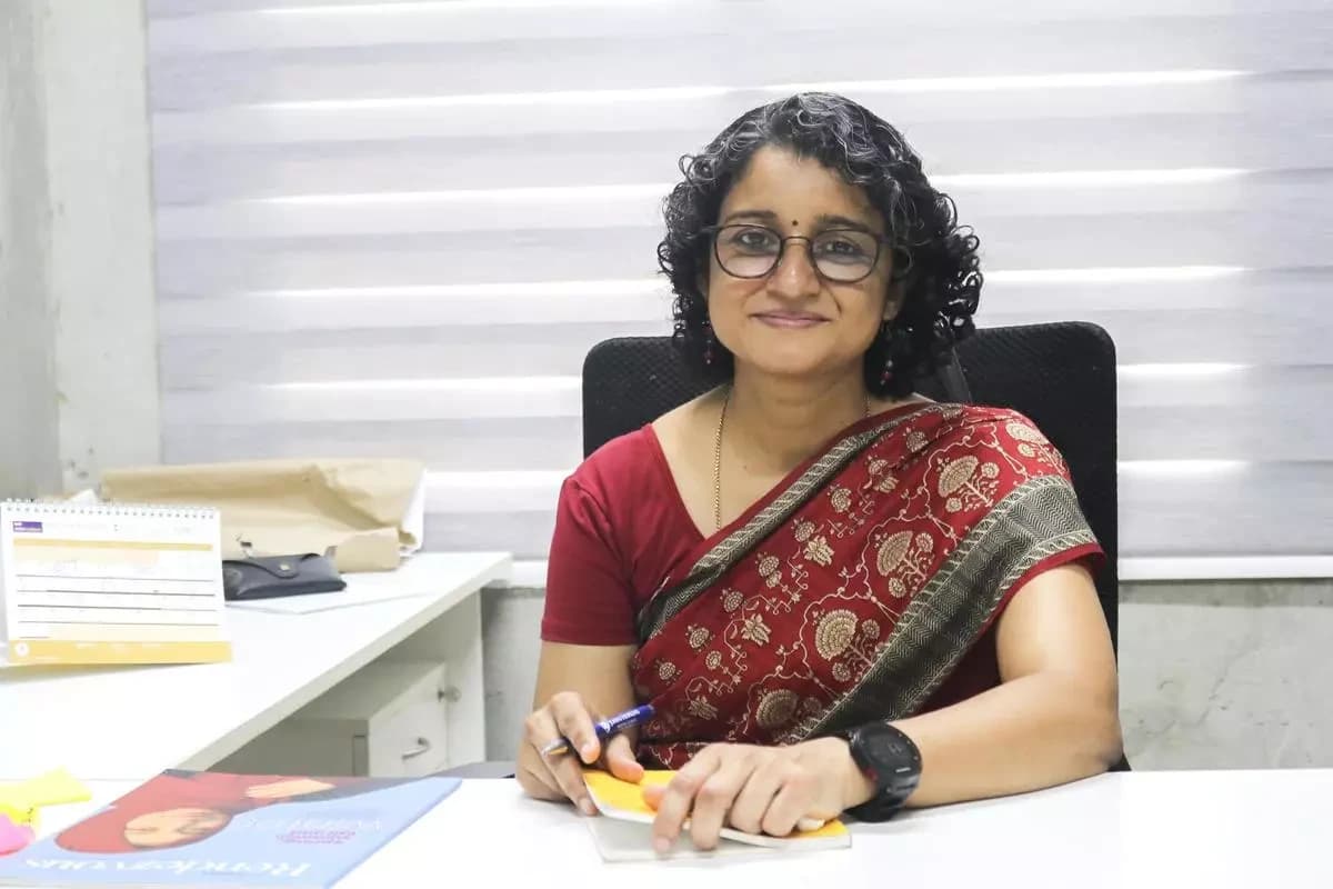 Preeti Aghalayam, director of IIT Zanzibar, seated at a desk.