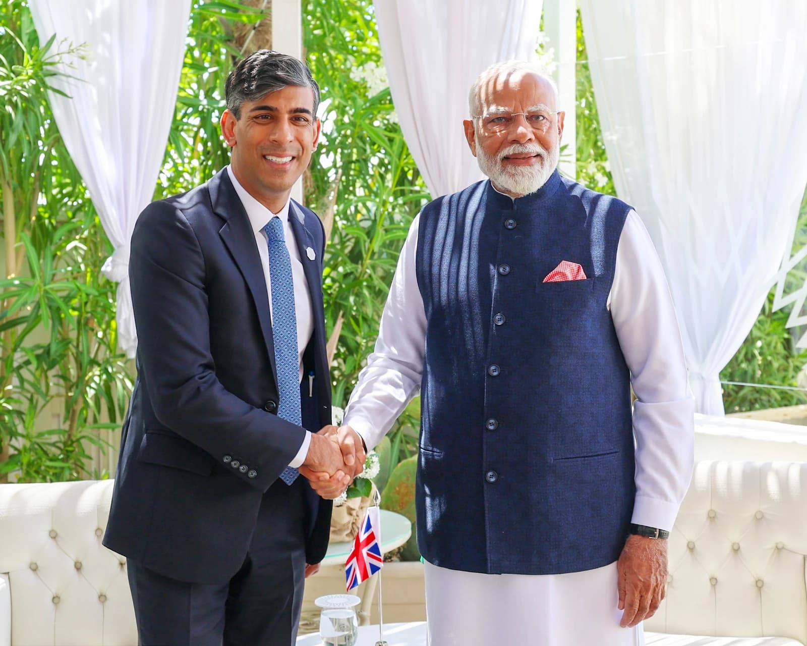 Narendra Modi, Prime Minister of India, and Rishi Sunak, Prime Minister of the United Kingdom, shaking hands.