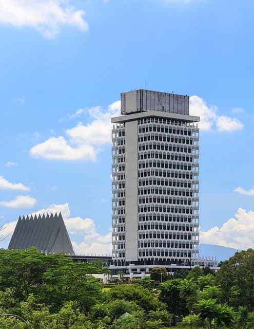 Parliament building in Kuala Lumpur, Malaysia, with a triangular roof building to the left.