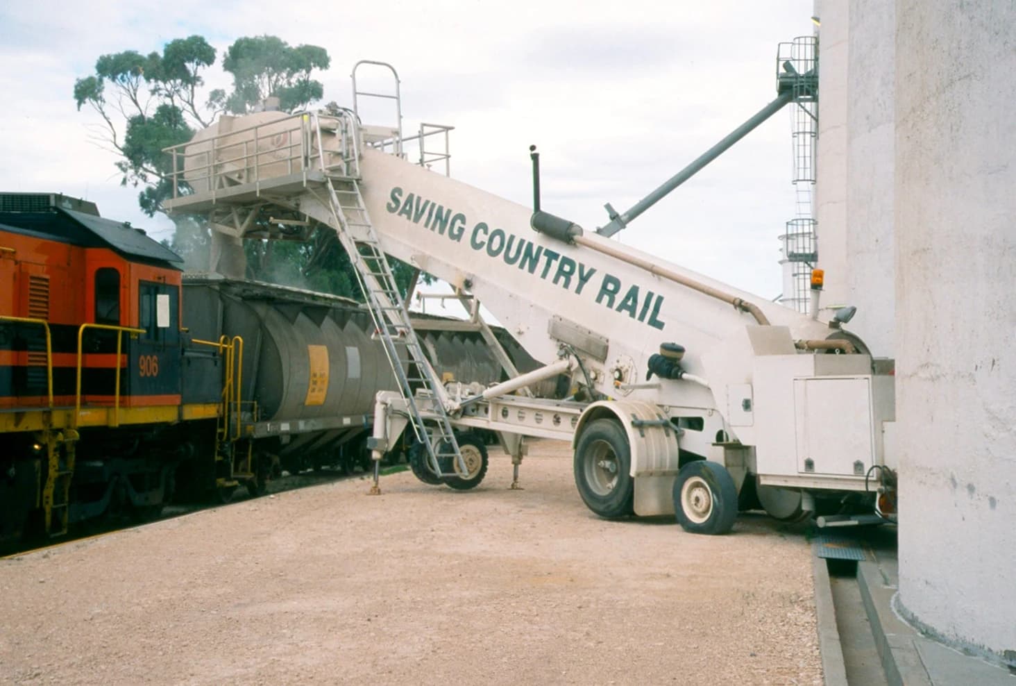 AusRailLoader, a mobile fast grain loader, loading grain onto train cars.