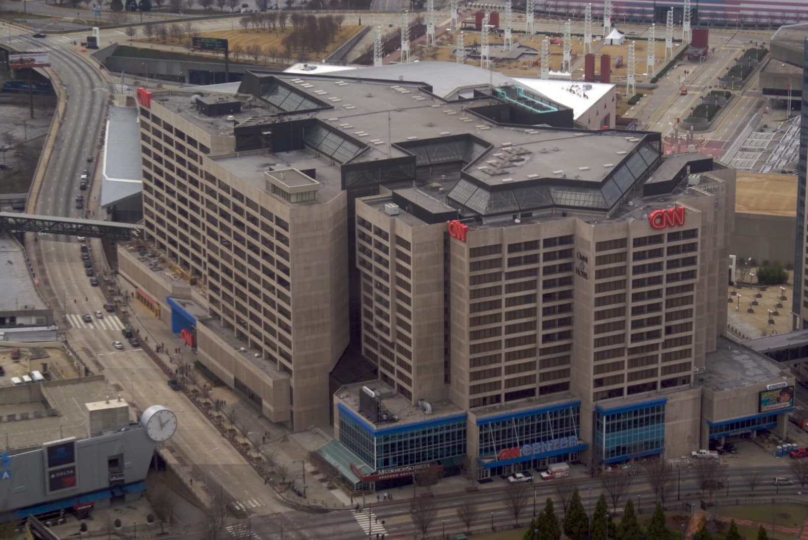 Aerial view of the CNN Center building in Atlanta, Georgia, with street and vehicles.