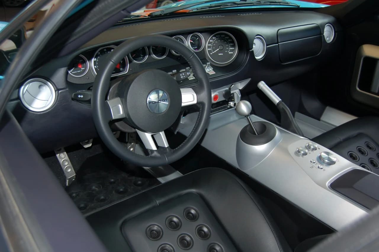 Interior view of a Ford GT sports car, showing the driver's seat, dashboard, and controls.