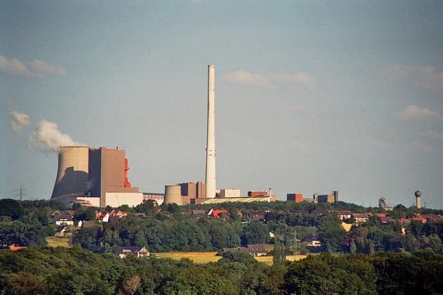 Ibbenbüren Power Plant with large cooling towers and a very tall smokestack.