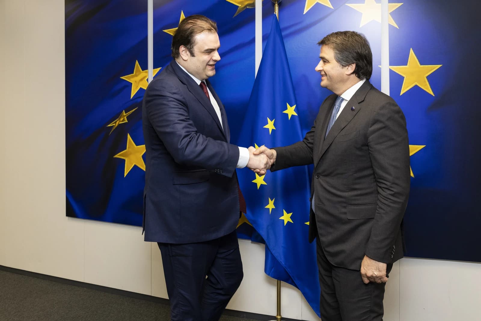 Kyriakos Pierrakakis, Greek Minister, shaking hands with an official at the European Commission.