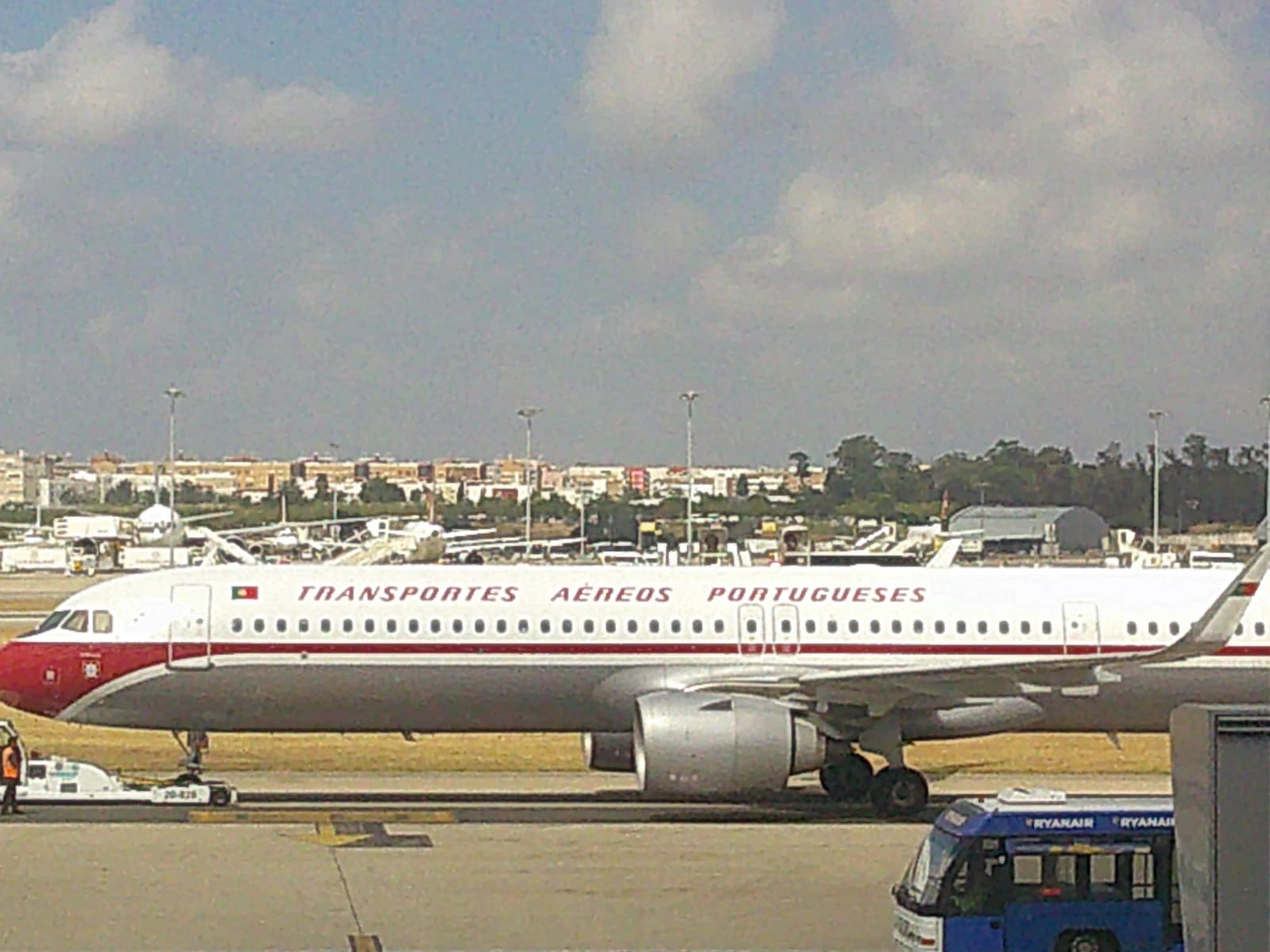 TAP Air Portugal aircraft on a runway at Lisbon Airport.