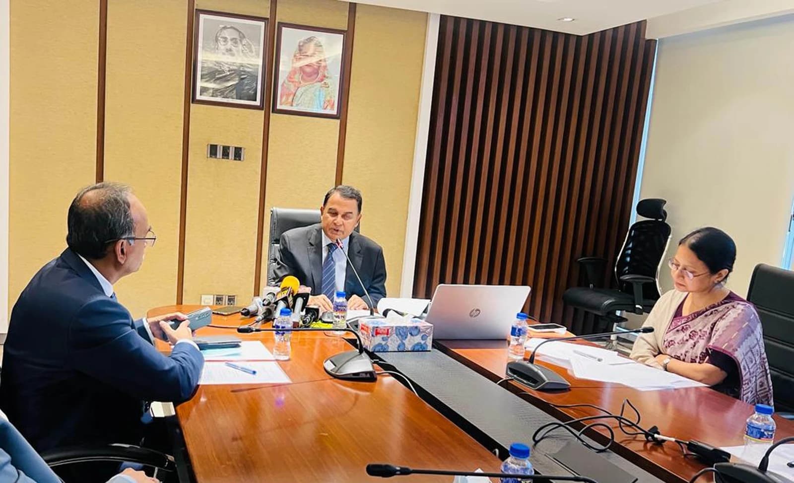 A H M Mustafa Kamal, Finance Minister of Bangladesh, speaks at a conference table.
