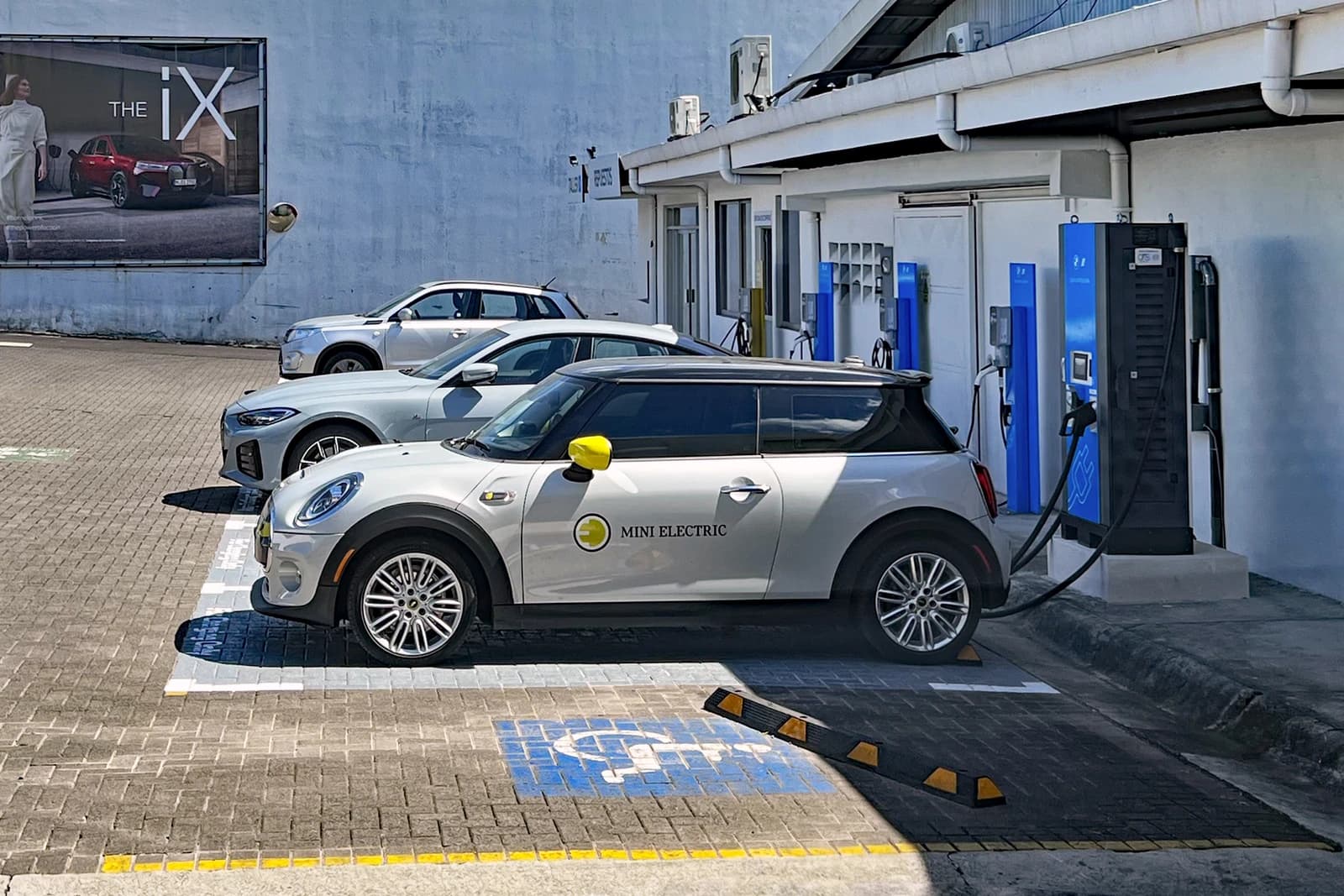 Mini Electric car charging at an electric vehicle charging station.