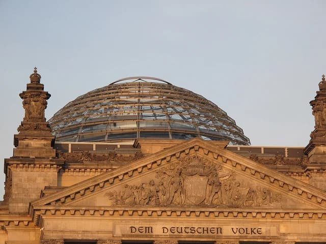 Close-up view of the glass dome and ornate facade of the Reichstag building in Berlin.