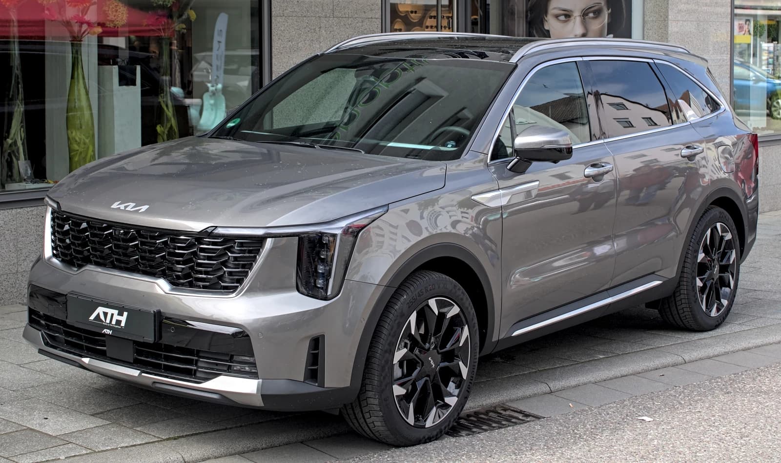 A gray 2024 Kia Sorento (MQ4) parked on a city street.
